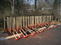 Large quantity of shovels, axes, and rakes.